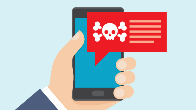 Hand holding smartphone shows text with skull and crossbones warning.