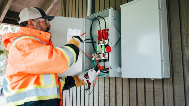 Electrician working with home electrical box